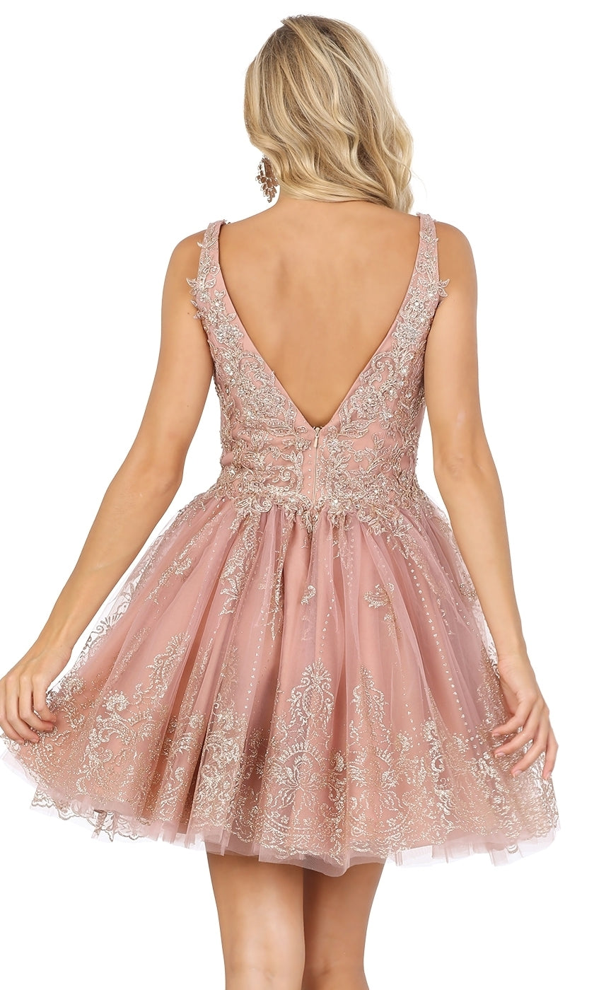 A woman stands with her back to the camera wearing the Silver-Beaded Short Babydoll Hoco Dress 3237, featuring a sleeveless design, deep V-back, beaded bodice, and flared short skirt.